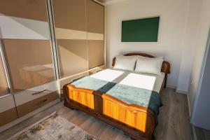 a small bedroom with a bed and a tv at G's Place in Prishtinë