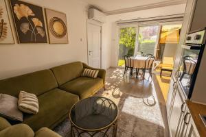 a living room with a couch and a table at G's Place in Prishtinë