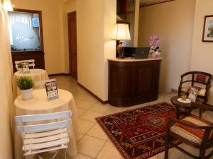 a room with two tables and a laptop on a podium at Le Camere DI Lucia Affittacamere in Colà di Lazise