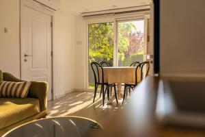 a living room with a table and chairs and a window at G's Place in Prishtinë +7 photos
