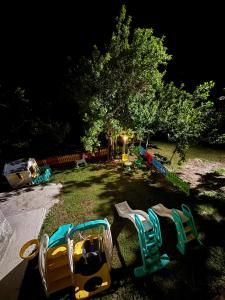 a group of playground equipment in a yard at night at LOPATE mountain stone house in Lopate