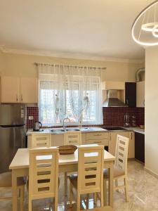 a kitchen with a table and chairs and a sink at Shkodra Central Corner in Shkodër