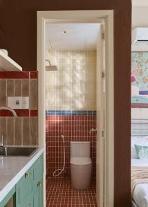 a bathroom with a toilet in a room at LangX Chapter Hotel & Apartment in Danang +51 photos