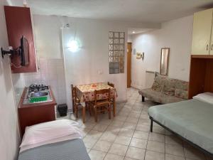 a small room with a kitchen and a table with a stove at Villamareblu in Ventimiglia