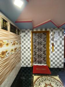 a door in a room with a checkered wall at Cameron Keafarm Hotel in Brinchang