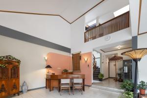 a dining room with a wooden table and chairs at Cove Rumah Asri in Bandung