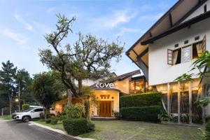 a house with a car parked in front of it at Cove Rumah Asri in Bandung