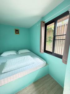 a bedroom with a bed and a window at BAN SUAN KRATOM CAFE AND RESORT in Nakhon Pathom +28 photos