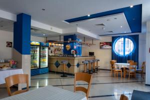a restaurant with blue walls and tables and chairs at Hotel Nadia in Primorsko