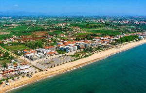 an aerial view of a beach with buildings and the ocean at Julia Country Home 200m from the Beach in Nea Plagia +19 photos