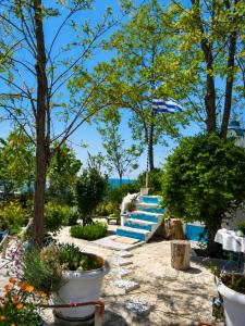 a row of stairs in a garden with trees at Julia Country Home 200m from the Beach in Nea Plagia