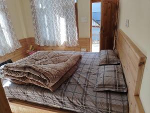 a bedroom with a large bed in a room at Peak Paradise homestay in Sainj