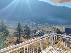 a view of a valley from a balcony at Peak Paradise homestay in Sainj