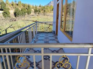 a balcony of a house with a view at Peak Paradise homestay in Sainj