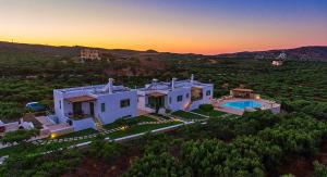 an aerial view of a house with a swimming pool at Liostasi Country Houses in Palekastron