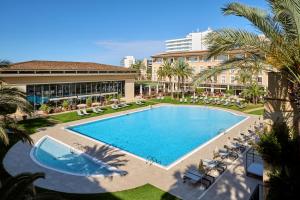an overhead view of a swimming pool at a resort at Grupotel Playa de Palma Suites & Spa in Playa de Palma