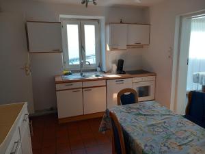 a small kitchen with a sink and a table with a table sidx sidx at Stegelshof 1 in Eygelshoven