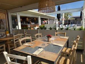a wooden table and chairs on a patio at Camping Village Butterfly in Peschiera del Garda