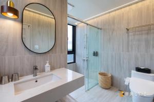 a bathroom with a sink and a mirror and a shower at 亮Villa in Sanxing +27 photos