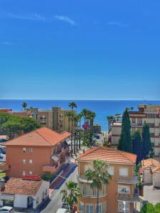 a view of a city with palm trees and the ocean at HOME PERLa in San Bartolomeo al Mare