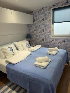 a bedroom with two beds with towels on them at Dolce Vita in Drage