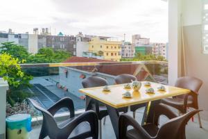 a table and chairs on a balcony with a view at LUNA House in Can Tho