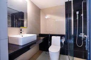 a bathroom with a white sink and a toilet at Lavendish Wild Safari in Wasgamuwa