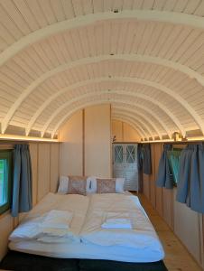 a large bed in the middle of a room at Schloss Sigrön Zirkuswagen in Bad Wilsnack
