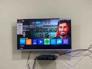 a flat screen tv sitting on top of a table at Redapple Rooms in Murree