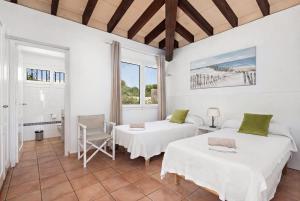 a room with two beds and a table at Villa Ribes by Escape Home in Binibeca +49 photos