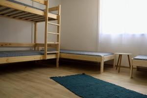 a bedroom with two bunk beds and a rug at DrótSzarvas Üdülőház in Bogács
