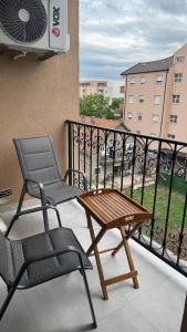 a balcony with a chair and a table and a fan at Apartman 38 in Stara Pazova