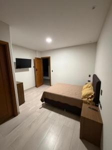 a bedroom with a bed and a television in it at Plaza Central Boutique House in Cochabamba +18 photos