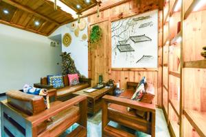 a living room with wooden walls and wooden furniture at Windmoon Hillcourt Tianmen Vis Lodge in Zhangjiajie