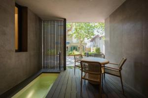 a room with a table and chairs and a swimming pool at Evangelisti Palace in Bellaria-Igea Marina
