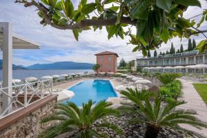 a resort with a swimming pool and a building at Park Hotel Casimiro in San Felice del Benaco