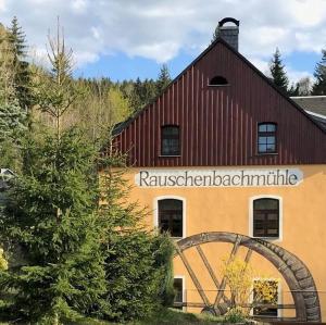 a building with a sign on the side of it at Ferienhaus Pfefferminzhütte in Mildenau