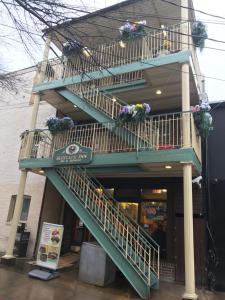 a staircase with flower pots on the side of a building at Inn on Main Annapolis in Annapolis