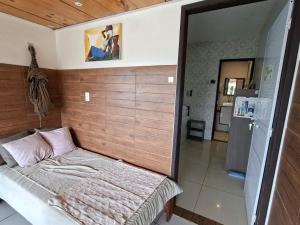 a small bedroom with a bed in a room at Pousada Rota do Pilão in Araçoiaba