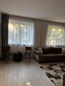 a living room with a couch and two chairs at Casa Good Vibes in Târgu-Mureş +38 photos