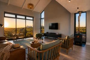 a living room with a couch and chairs and a piano at 401 Kingfisher in Gansbaai +58 photos