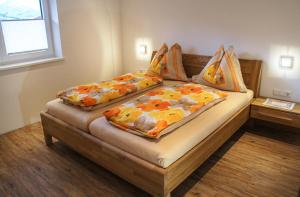 two beds sitting in a room with at Ferienwohnungen Perterer in Fieberbrunn