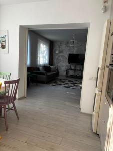 a living room with a couch and a table at Casa Good Vibes in Târgu-Mureş