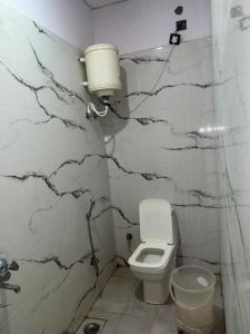 a bathroom with a toilet and a sink at Kailashi Hotel Har ki pauri in Haridwār +12 photos