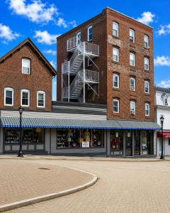 a large brick building with a fire escape at Fall River Stay Stylish 2BR Urban Haven Suite in Fall River +3 photos