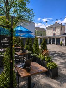an outdoor patio with a table with a laptop on it at Fall River Stay Stylish 2BR Urban Haven Suite in Fall River