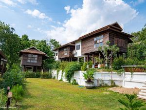 a house with a yard in front of it at บ้านริมดอย แม่ริม in Ban Mae Raem