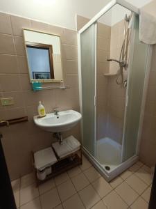 a bathroom with a sink and a shower at Maurin in Carrara +15 photos