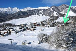 a small town on a snow covered mountain at PEUF Lodge in Otari