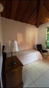 a bedroom with a bed and a table with a lamp at Curlt stays in Kampala